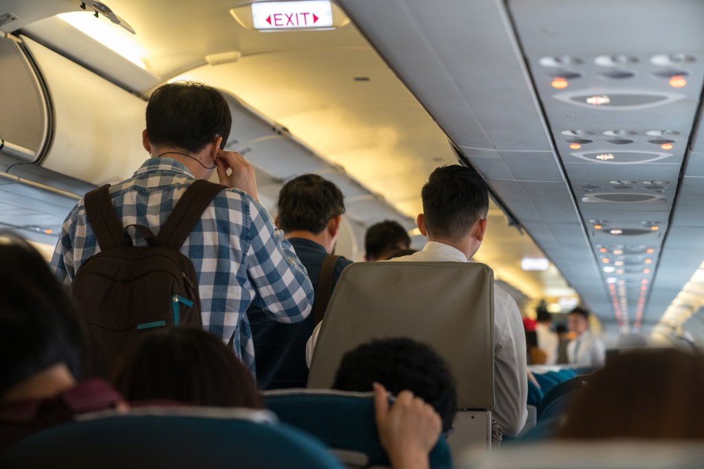 People standing in a plane booth preparing to destroy after a flight